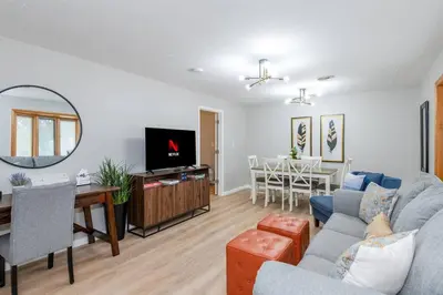 a living room with a couch and a table at Sweet Magnolia - Newly Remodeled Ranch in Englewood