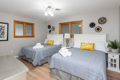 a bedroom with two beds with towels on them at Sweet Magnolia - Newly Remodeled Ranch in Englewood