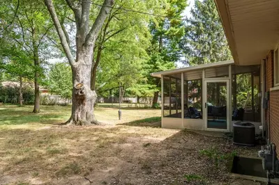 a house with a tree in the yard at Sweet Magnolia - Newly Remodeled Ranch in Englewood