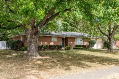 a house with two trees in front of it at Sweet Magnolia - Newly Remodeled Ranch in Englewood