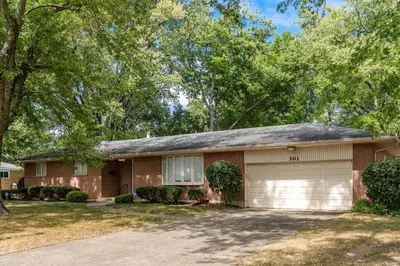 a brick house with a garage and trees at Sweet Magnolia - Newly Remodeled Ranch in Englewood