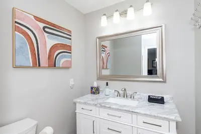 a bathroom with a sink and a mirror at Sweet Magnolia - Newly Remodeled Ranch in Englewood