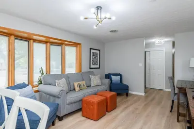 a living room with a couch and a table at Sweet Magnolia - Newly Remodeled Ranch in Englewood