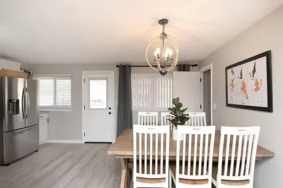 a kitchen with a table and chairs and a refrigerator at Sunny Ranch - Newly Remodeled in Dayton