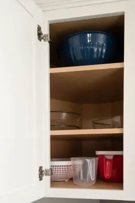 a cupboard with a blue bowl and other kitchen items at Sunny Ranch - Newly Remodeled in Dayton