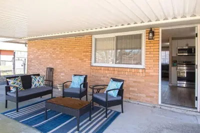 a patio with chairs and a table and a brick wall at Sunny Ranch - Newly Remodeled in Dayton