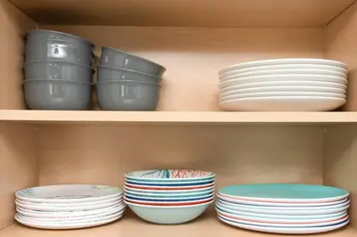 a shelf with plates and bowls in a cabinet at Sunny Ranch - Newly Remodeled in Dayton