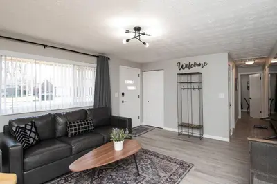 a living room with a black couch and a table at Sunny Ranch - Newly Remodeled in Dayton