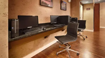 a office with four computer monitors on a desk at Baymont Inn & Suites in Marietta