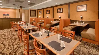 a restaurant with tables and chairs in a room at Baymont Inn & Suites in Marietta