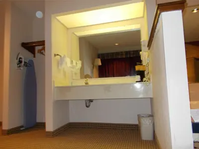 a bathroom with a sink and a large mirror at Royalton Inn and Suites, Wilmington,Ohio in Wilmington