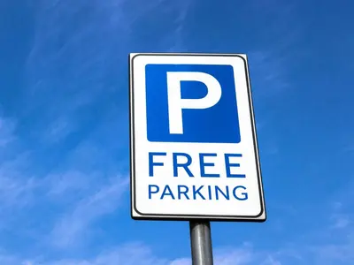 a free parking sign in front of a blue sky at Royalton Inn and Suites, Wilmington,Ohio in Wilmington