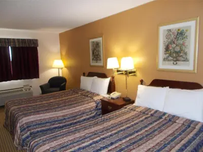 a hotel room with two beds and a telephone at Royalton Inn and Suites, Wilmington,Ohio in Wilmington