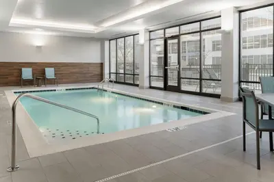 a large swimming pool in a building with windows at TownePlace Suites by Marriott Cincinnati Oakley in Cincinnati