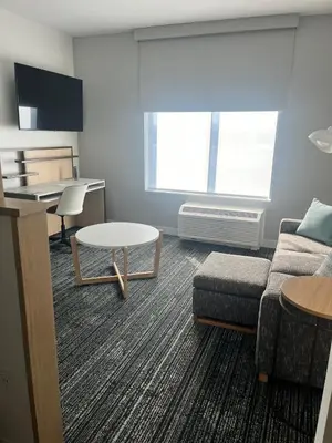 a living room with a couch and a table at TownePlace Suites by Marriott Cincinnati Oakley in Cincinnati