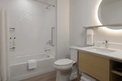 a white bathroom with a toilet and a sink at TownePlace Suites by Marriott Cincinnati Oakley in Cincinnati