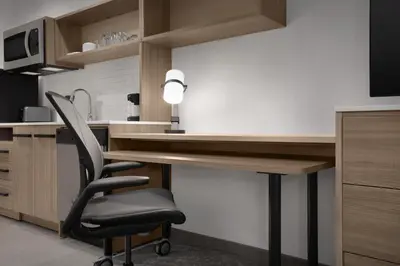 a kitchen with a desk and a black chair at Home2 Suites By Hilton Columbus Easton in Columbus