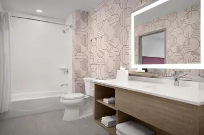 a bathroom with a sink and a mirror and a toilet at Home2 Suites By Hilton Columbus Easton in Columbus