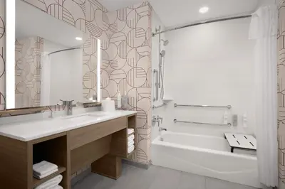 a bathroom with a tub and a sink and a bath tubermott at Home2 Suites By Hilton Columbus Easton in Columbus