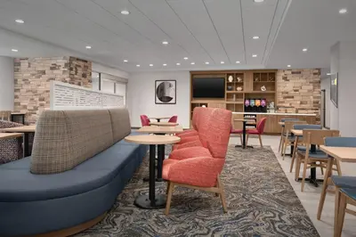 a restaurant with a blue couch and chairs and tables at Home2 Suites By Hilton Columbus Easton in Columbus
