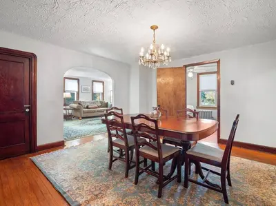 a dining room with a wooden table and chairs at Willow Woods Retreat - Farmhouse - Patio & Nature in Kirtland