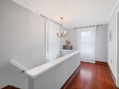 a hallway with white walls and a long white counter at Willow Woods Retreat - Farmhouse - Patio & Nature in Kirtland