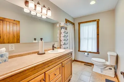 a bathroom with a sink and a toilet at Wooded Escape with Pond and Grill in Pleasant City! in Senecaville
