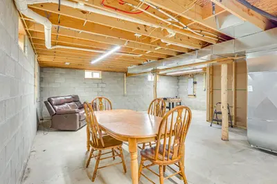 a kitchen with a table and chairs in a room at Wooded Escape with Pond and Grill in Pleasant City! in Senecaville