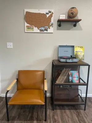 a chair sitting next to a desk with a laptop at Spacious 3-bedroom home in Archbold in Archbold