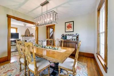 a dining room with a wooden table and chairs at Countryside Home in Wooster with Patio and Fire Pit in Wooster