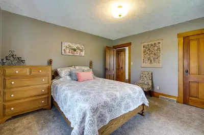 a bedroom with a bed and a wooden dresser at Countryside Home in Wooster with Patio and Fire Pit in Wooster