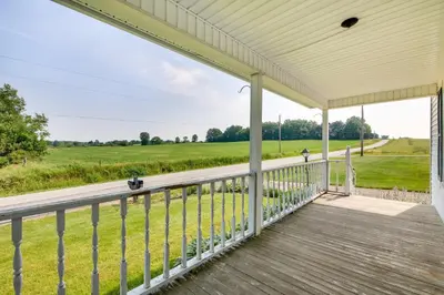 a porch with a view of a field at Countryside Home in Wooster with Patio and Fire Pit in Wooster