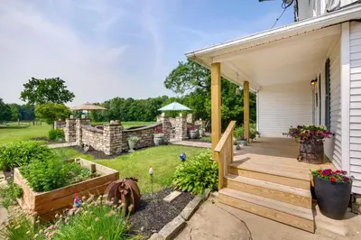 a backyard with a wooden deck and a garden at Countryside Home in Wooster with Patio and Fire Pit in Wooster