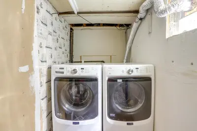 two washing machines sitting in a laundry room at Vermilion Home - Walk to Main Street Beach! in Vermilion