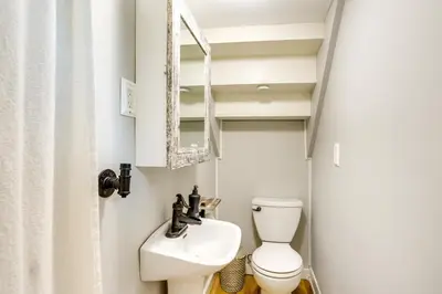 a small bathroom with a toilet and a sink at Vermilion Home - Walk to Main Street Beach! in Vermilion