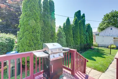 a grill on a pink railing on a yard at Vermilion Home - Walk to Main Street Beach! in Vermilion