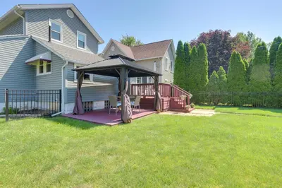 a house with a deck with an umbrella at Vermilion Home - Walk to Main Street Beach! in Vermilion