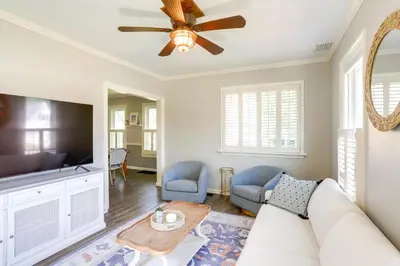 a living room with a couch and a tv at Vermilion Home - Walk to Main Street Beach! in Vermilion