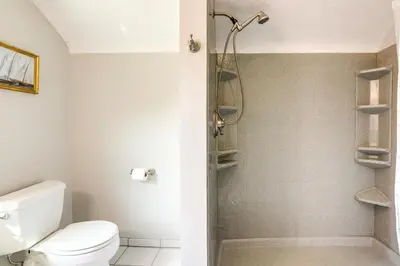 a bathroom with a toilet and a shower at Vermilion Home - Walk to Main Street Beach! in Vermilion