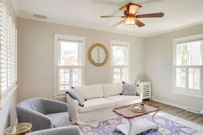 a living room with a couch and a ceiling fan at Vermilion Home - Walk to Main Street Beach! in Vermilion