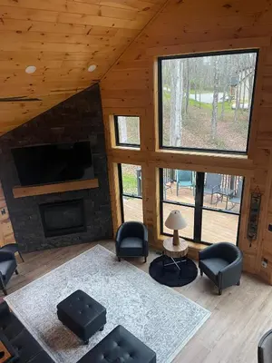 a living room with a fireplace and a tv at The Saige - Hot Tub, Fire Pit, and huge entertainment area in Logan