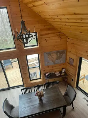 a dining room with a table and chairs in a cabin at The Saige - Hot Tub, Fire Pit, and huge entertainment area in Logan