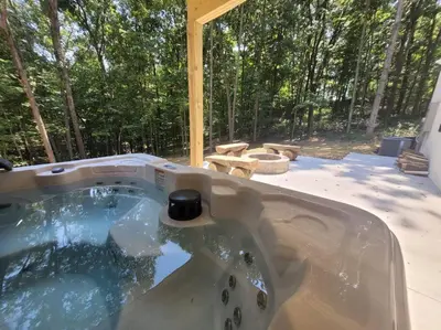 a hot tub in the middle of a backyard at The Quana - Hot tub, fire pit, and Huge Entertainment Area in Logan