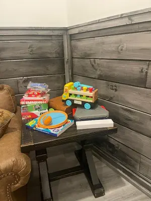 a table with a toy train and books on it at The Quana - Hot tub, fire pit, and Huge Entertainment Area in Logan