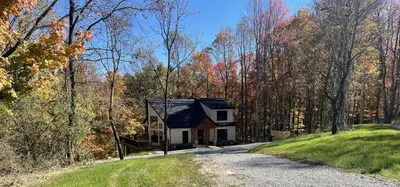 a small house in the middle of a road at The Quana - Hot tub, fire pit, and Huge Entertainment Area in Logan