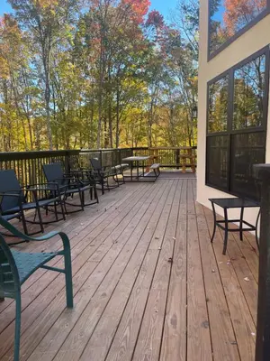 a deck with benches and tables on a building at The Quana - Hot tub, fire pit, and Huge Entertainment Area in Logan