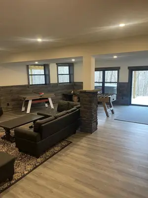a living room with a couch and a table at The Quana - Hot tub, fire pit, and Huge Entertainment Area in Logan