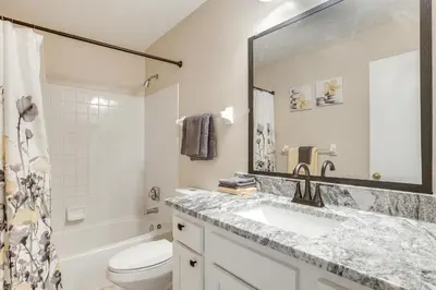 a bathroom with a sink and a toilet and a mirror at 8 Mi to Downtown Pet-Friendly Columbus Home in Columbus