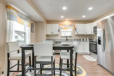 a kitchen with a table and chairs and a refrigerator at 8 Mi to Downtown Pet-Friendly Columbus Home in Columbus