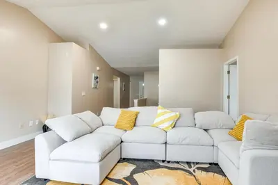 a living room with a white couch and yellow pillows at 8 Mi to Downtown Pet-Friendly Columbus Home in Columbus